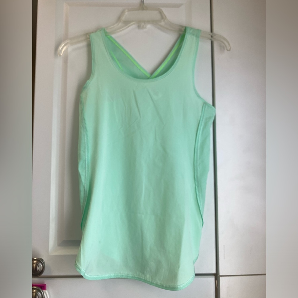 Ivivva size 12. Mint green tank with netted criss cross in the back.